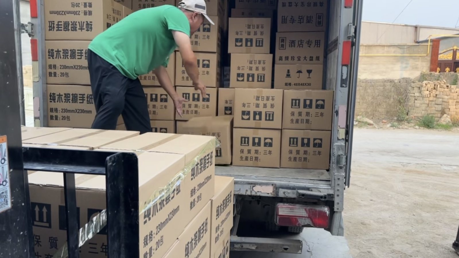 Workers loading cartons into a shipping container