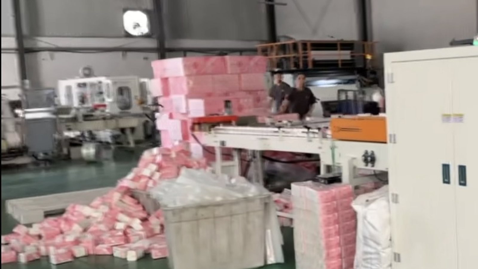 Worker packing cartons in a warehouse